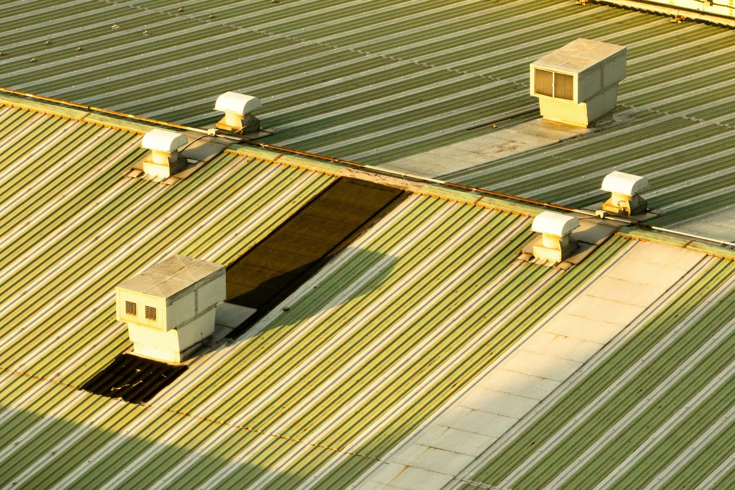 Corrugated metal commercial roof with rooftop ventilators