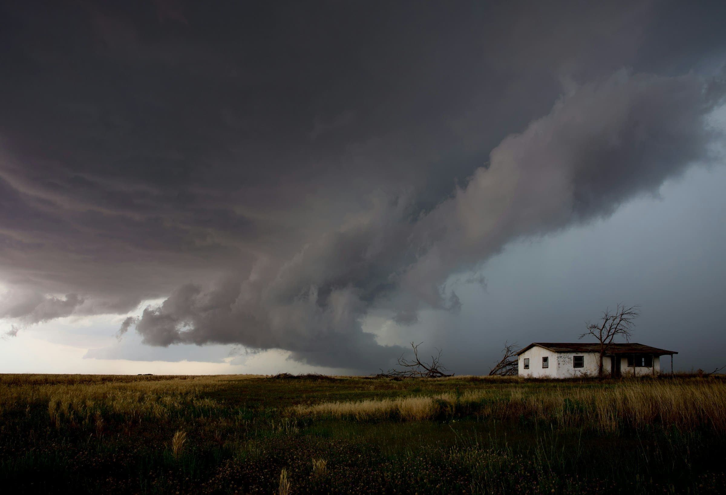 Storm clouds building over a lone house