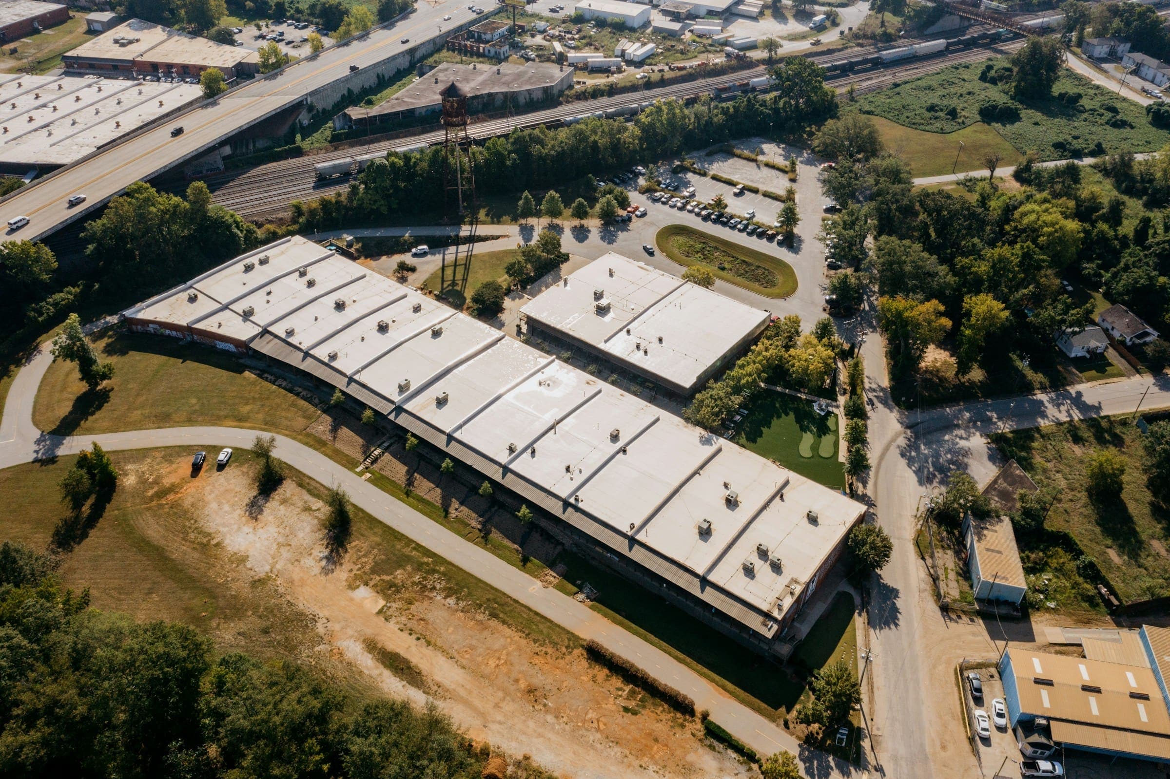 Aerial view of low-slope commercial buildings with white membrane roofs