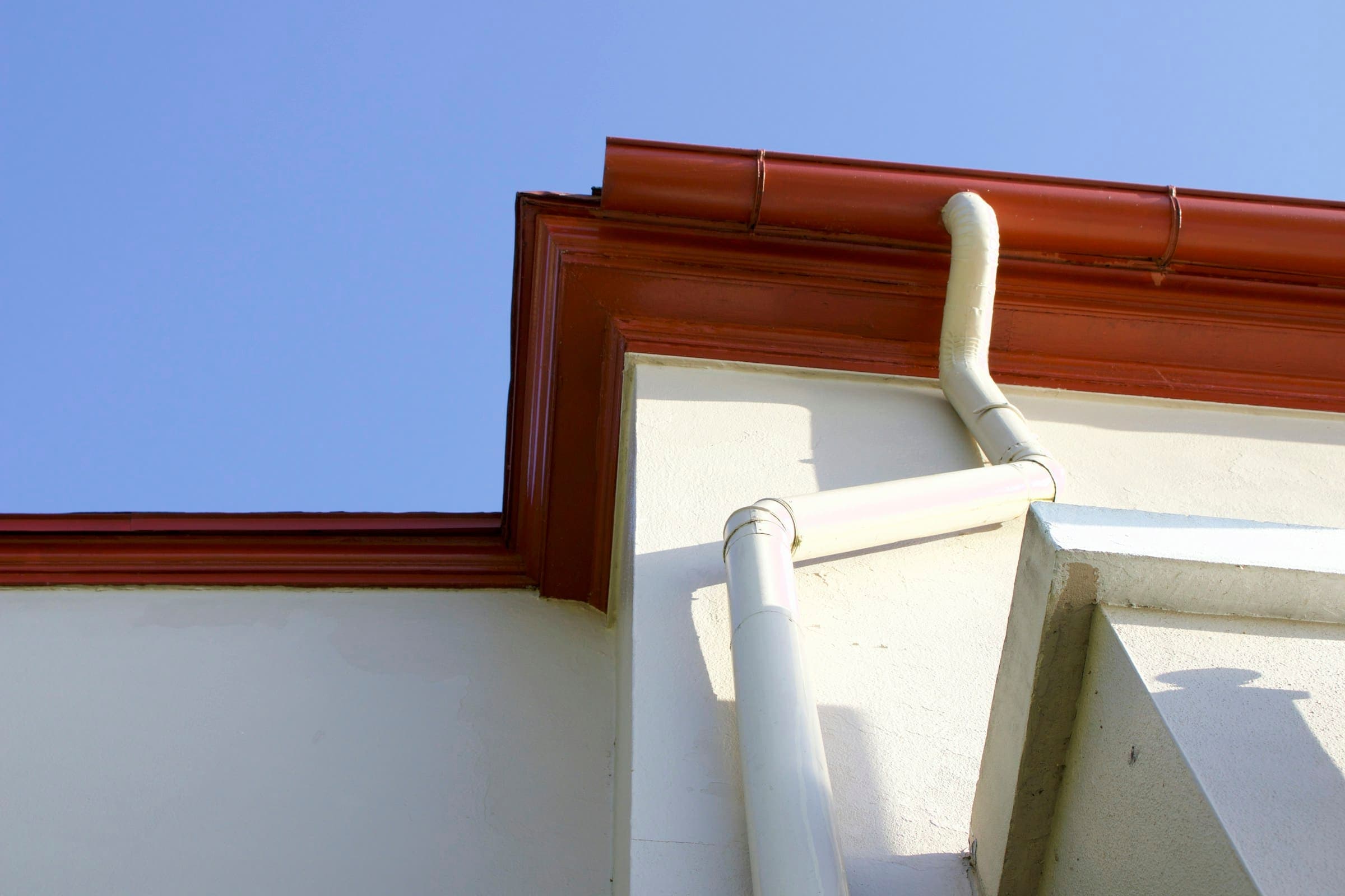 Seamless gutter and downspout on a white fascia